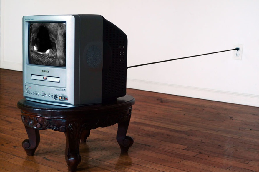 Nida Sinnokrot, Barking Dog, 2000. T.V, carved wood stool, DVD, dimensions variable.