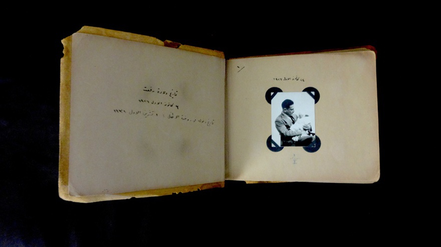 First spread of the album compiled by Kamil Chadirji, documenting major milestones of his son's childhood. The photograph shows Kamil holding an infant Rifat on December 24, 1926.
