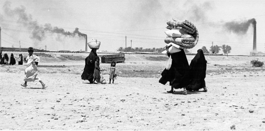 Photograph from the Chadirji collection showing women and children near a brick factory, outskirts of Baghdad.
