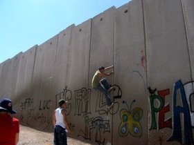 Members of G-Town climbing the Separation Wall at Shu'afat Camp, 2008