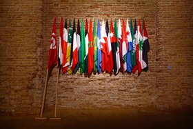 Mounir Fatmi, The Lost Springs, 2011, installation detail, The Future of a Promise, 2011, 2 brooms of 3 metres, 22 flags of the Arab League.