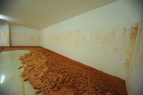 Latifa Echakhch, Tkaf, 2011, installation view, bricks and pigment. Courtesy of the artist and Kamel Mennour, Paris. Image courtesy of Sharjah Art Foundation.