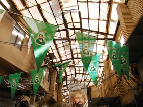 Imam Hussein's picture is visible on posters or flags at the Suq as-Safafir, in Rusafa.