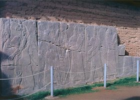 Nimrud, walls of Asurnasirpal's ca. 875-860 B.C.Views of wall slabs sculpt- ed with Assyrian rituals and deities. The sculptures were damaged by looters in 2003.