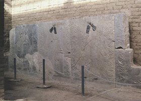 Nimrud, walls of Asurnasirpal's ca. 875-860 B.C.Views of wall slabs sculpt- ed with Assyrian rituals and deities. The sculptures were damaged by looters in 2003.