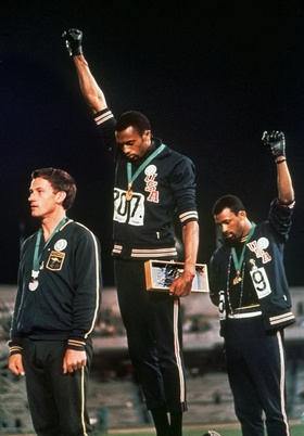 Winners' podium for the 200m race at the 1968 Olympics. Tommie Smith and John Carlos give the Black Power salute.