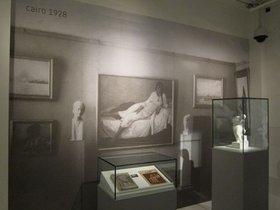 Mahmoud Moukhtar, Fellahah at the Nile. Plaster sculpture. Exhibition view at Mathaf in Doha with enlarged photograph of The 1927 exhibition of Mahmoud Moukhtar and La Chimère Group at 14 Antikhana Street in Cairo (1927).