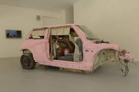 Sarah Abu Abdallah, Saudi Automobile, 2011, colour video LCD with sound, scrap car and pink paint. Courtesy of the artist and Alāan Artspace, Riyadh. Image courtesy of Sharjah Art Foundation.