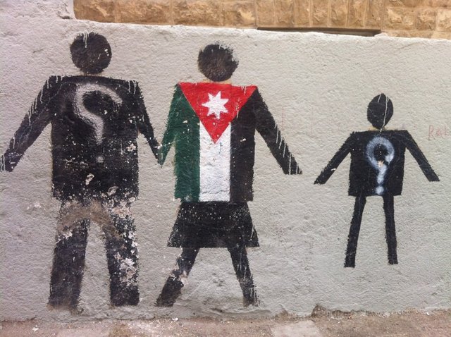 Graffiti wall art illustrating the dilemma of Jordanian women married to Palestinian refugees being unable to gain Jordanian citizenship, Jabal al-Nadif, 2012. Photograph by Yasmin Khan.