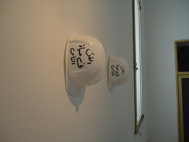 Ayşe Erkmen, Construction, 2012 (2009), calligraphy on builders helmets for an intervention at the Bardo Museum. Courtesy the artist and Galerie Barbara Weiss. Photograph © ATP/Ibraaz Publishing, 2012.