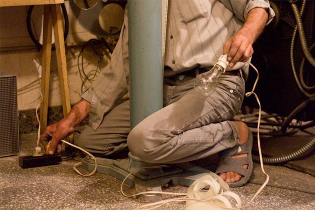 A projectionist tests replacement bulbs.