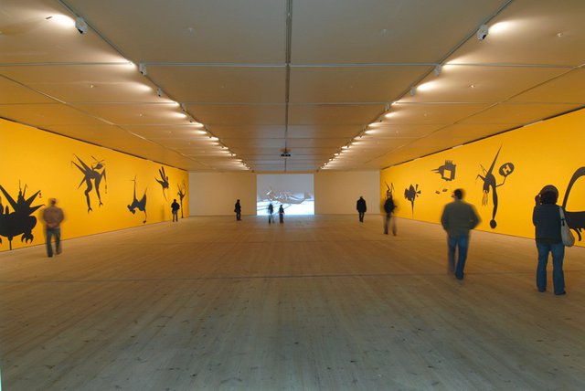 Mona Marzouk, The Bride Stripped Bare by Her Energy's' Evil, 2006, two large scale wall paintings (10 m each + acrylic colors), audio elements and a projected short 3D animated film,  2 min. 44 sec. Installation view at BALTIC Centre for Contemporary Art, Gateshead, UK.