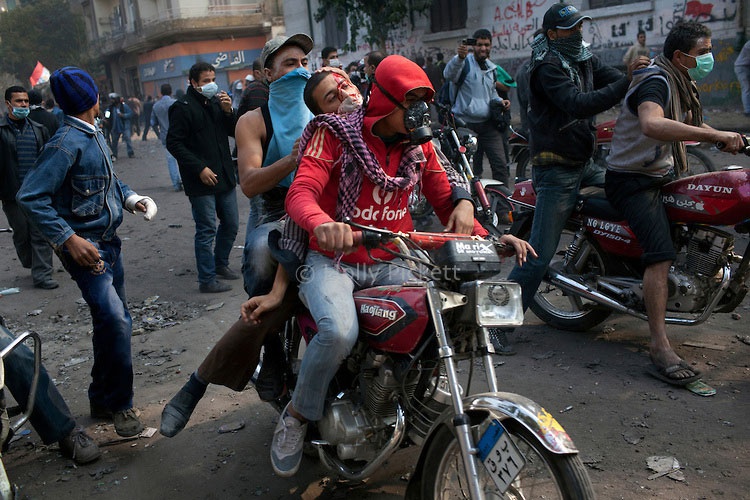 Protesters carry wounded to a field hospital near Tahrir square, Cairo, Egypt, 2011.