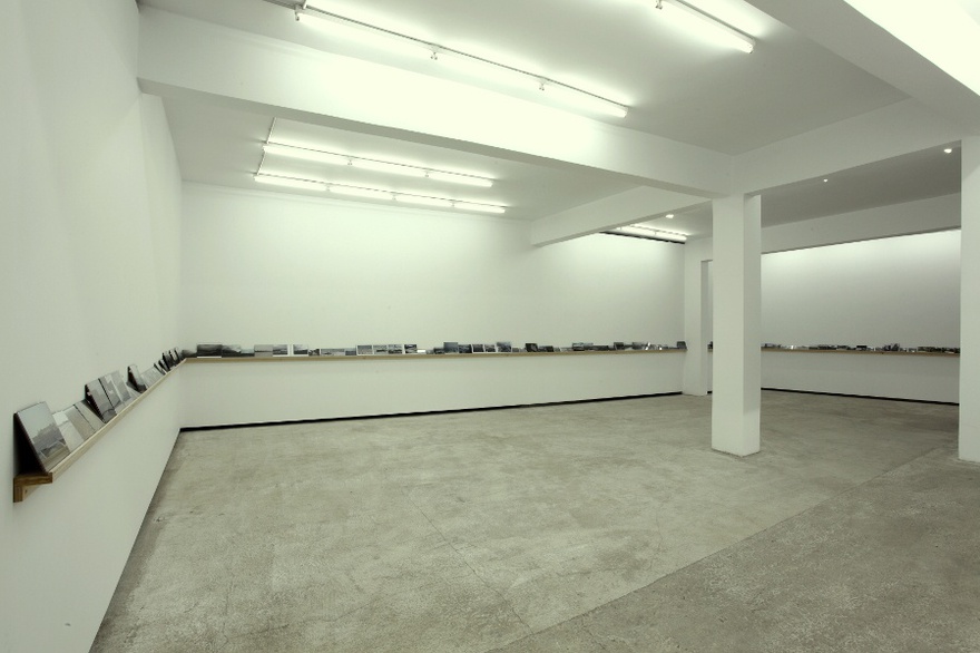 Vangelis Vlahos, Is There Any Oversight On Ocalan?, 2009-2011. 119 photos (variable dimensions) on a wall mounted shelf (23m). Installation view at The Breeder gallery, Athens, 2011.