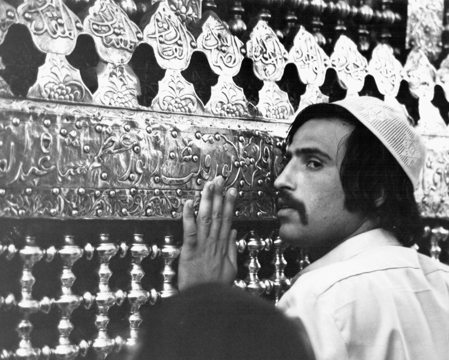 Photograph from the Chadirji collection showing man praying at the shrine of a venerated Imam, Baghdad.