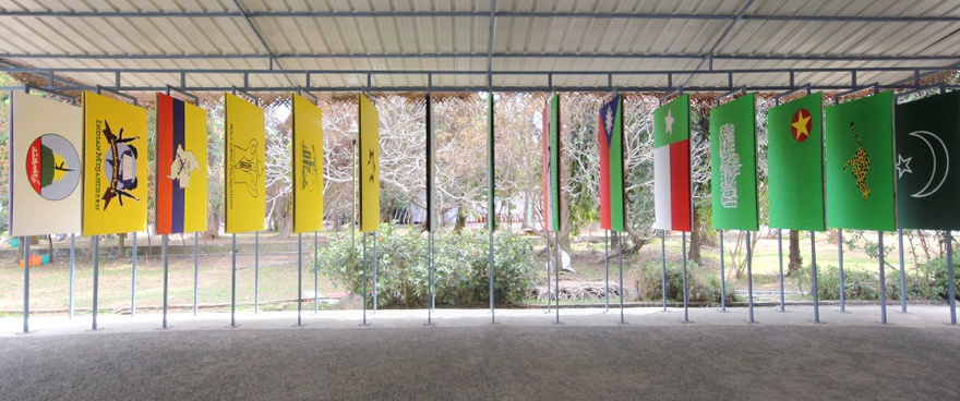 New World Summit – Kochi, 2013. Detail from the parliament of the 3rd New World Summit in Kochi, India, built as an extension of a former British colonial complex, showcasing panels with flags of organizations dealing with international blacklisting organized by color.