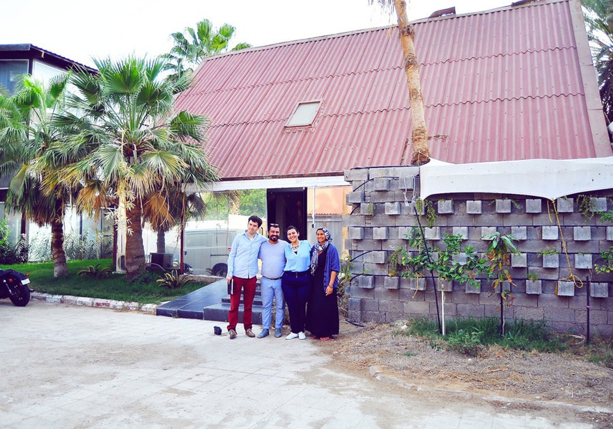 The three co-founders and a friend in front of Onqoud Studio.